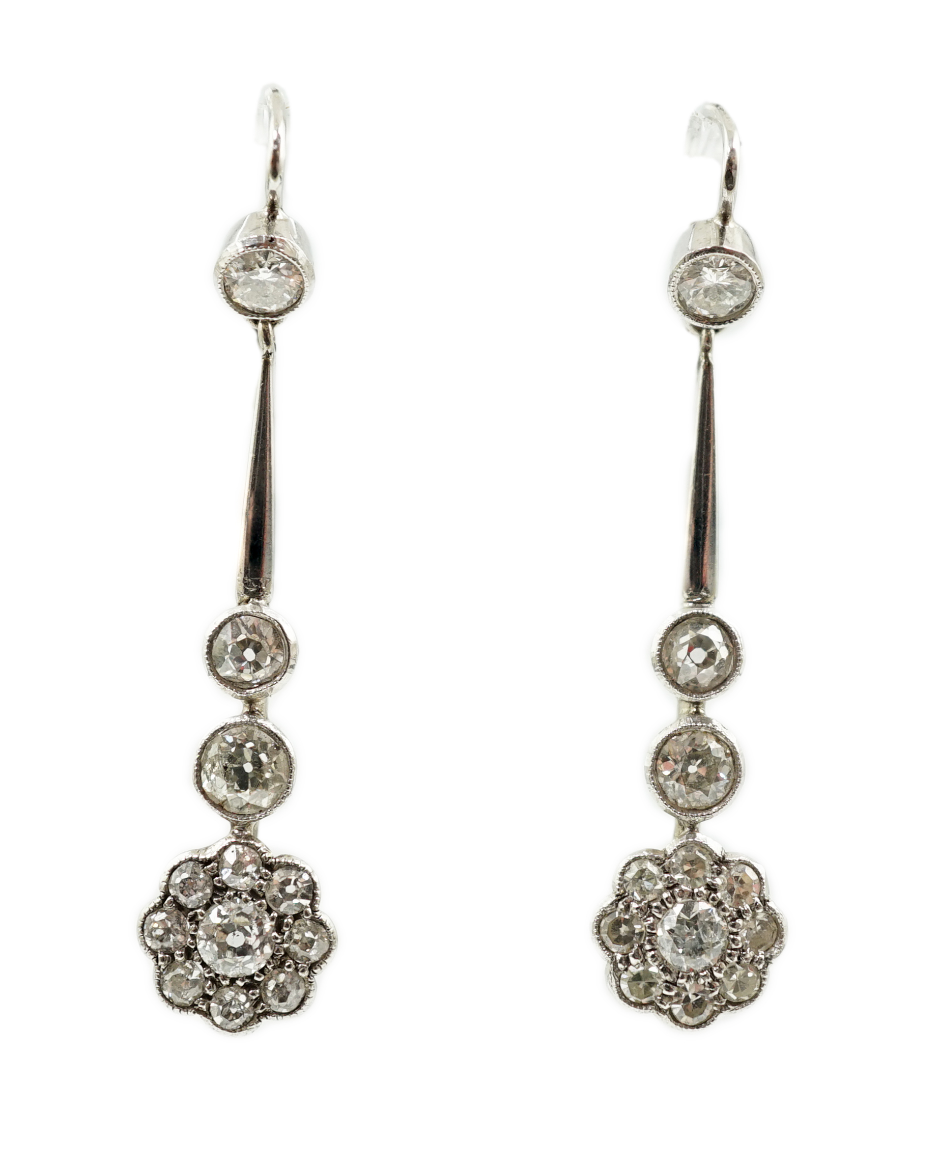 A pair of 1920's style platinum? and millegrain set diamond cluster drop earrings